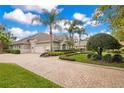 Charming home with paved driveway, lush landscaping, and side entry garage at 5241 Vista Club Run, Sanford, FL 32771
