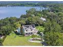 An aerial view of a beautiful home nestled amongst the trees with lake views at 5351 Carson St, St Cloud, FL 34771