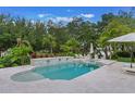 Inviting backyard pool and spa area with tiled surround and lush landscaping, ideal for outdoor relaxation at 5351 Carson St, St Cloud, FL 34771
