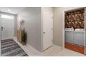 Inviting entryway with neutral tones, stylish decor, and convenient access to the laundry room at 5515 Palomino Pl, Apopka, FL 32712