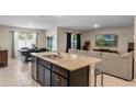 Open-concept living space featuring a spacious kitchen island and a comfortable living area at 5515 Palomino Pl, Apopka, FL 32712