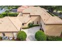 Aerial view of a tile roof home with a pool, mature landscaping, and portico at 6149 Blakeford Dr, Windermere, FL 34786