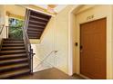 Hallway leading to unit 208 with a staircase at 6335 Contessa Dr # 208, Orlando, FL 32829