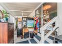 Enclosed porch featuring stairs, interior access, an eclectic mix of furnishings, and plenty of natural light at 9000 Us Highway 192 # 115, Clermont, FL 34714
