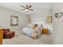 Cozy bedroom featuring carpeted floors, ceiling fan, neutral walls, and a comfortable queen size bed at 9846 Sw 106Th Ct Ocala, F, Ocala, FL 34481