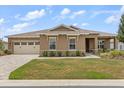 Charming single-story home with manicured lawn, stone accents, and a neutral color palette at 9846 Sw 106Th Ct Ocala, F, Ocala, FL 34481