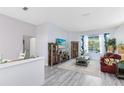 Spacious living room features hardwood floors and a large window; adjacent to a dining area at 10743 Fairhaven Way, Orlando, FL 32825