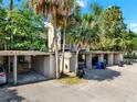 Carport area, surrounded by trees and greenery, offering convenient covered parking at 109 Crown Oaks Way # 109, Longwood, FL 32779