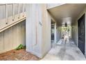 Exterior view of unit 109 with private entry and wooden stairs, set in a lush landscape at 109 Crown Oaks Way # 109, Longwood, FL 32779