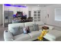 Bright living room next to modern kitchen featuring hardwood floors and a comfortable sofa at 1418 Kissimmee Ct, Kissimmee, FL 34759