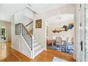 Bright foyer with hardwood floors, staircase, and an archway that leads to a dining area with stylish decor at 1420 Palmer Ave, Winter Park, FL 32789
