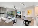 Bright living room featuring modern furniture, a ceiling fan, and a private balcony with outdoor seating at 14501 Grove Resort Ave # 2451, Winter Garden, FL 34787