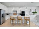 Bright kitchen with white cabinets, stainless steel appliances, a kitchen island, and pendant lighting at 15053 Willow Ridge Dr, Montverde, FL 34756