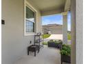 A view of the front porch with patio plants and bright light at 15096 Chapter Way, Winter Garden, FL 34787