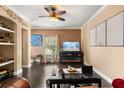 Inviting living room with dark floors, fan, and decorative fireplace, creating a cozy ambiance at 173 Villa Di Este Ter # 209, Lake Mary, FL 32746