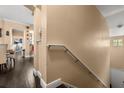 Bright stairwell with hardwood steps and trim, featuring neutral walls and a convenient handrail at 173 Villa Di Este Ter # 209, Lake Mary, FL 32746