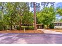 Well-maintained single-story home with mature trees and a covered carport, providing shade and curb appeal at 203 N Forest Blvd, Lake Mary, FL 32746