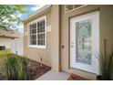 Inviting front entrance with decorative glass door and manicured landscaping at 2306 Valhalla Dr, Tavares, FL 32778