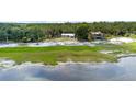 Expansive aerial view showcasing the waterfront property, lush greenery, and serene surroundings at 2518 Fort Lane Rd, Geneva, FL 32732