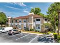 Well-maintained condo building with dedicated parking and landscaped surroundings at 2930 S Semoran Blvd # 408, Orlando, FL 32822