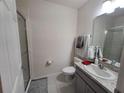 Neat bathroom with a shower, vanity, granite countertop, sink, and chrome hardware at 3316 Bellissimo Ave, Kissimmee, FL 34746