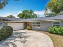 Inviting one-story home with lush front yard landscaping and convenient attached garage at 3443 Arnel Dr, Winter Park, FL 32792