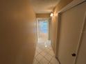 Hallway with neutral walls and glossy tile flooring leading to the living area at 510 Cranes Way # 302, Altamonte Springs, FL 32701