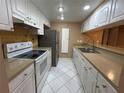 Bright kitchen with white cabinetry, and efficient appliance arrangement at 510 Cranes Way # 302, Altamonte Springs, FL 32701