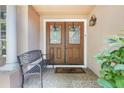 Inviting entryway features a double-door entry, seating, and a welcoming 'hello' doormat at 5113 Mystic Point Ct, Orlando, FL 32812