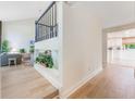 Open-concept living area with hardwood floors and staircase leading upstairs at 5113 Mystic Point Ct, Orlando, FL 32812