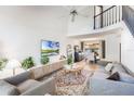 Bright living room with high ceilings, a ceiling fan, and an adjacent dining area at 5113 Mystic Point Ct, Orlando, FL 32812