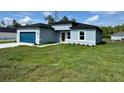 Charming single-story home with a blue garage door and freshly cut green lawn at 529 Marion Oaks Ln, Ocala, FL 34473
