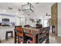 Open-concept dining space with a wooden table adjacent to a kitchen and fireplace at 5575 Garden Grove Cir, Winter Park, FL 32792