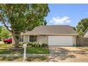 Traditional style home with an attached garage and well-manicured front yard showcasing curb appeal at 5575 Garden Grove Cir, Winter Park, FL 32792