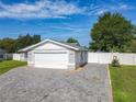 View of the home's front exterior, showcasing the lush green lawn, driveway, and attached garage at 7911 Murcott Cir, Orlando, FL 32835