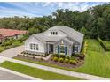 Elegant single-story home featuring stone accents, a well-manicured lawn, and mature trees at 8080 Peaceful Cir, Sanford, FL 32771
