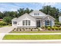 Inviting single-story home showcasing manicured landscaping, stone accents and a neutral color palette at 8080 Peaceful Cir, Sanford, FL 32771