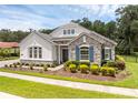 Charming single-story home with well-maintained landscaping, stone details and blue shutters at 8080 Peaceful Cir, Sanford, FL 32771
