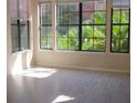 Bright living room featuring multiple windows offering ample natural light and beautiful outdoor views at 911 N Orange Ave # 335, Orlando, FL 32801
