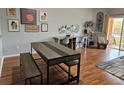 Bright dining area with sliding glass doors, wood-look flooring, and a large work desk at 1022 Calabria Ave, Davenport, FL 33897