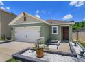 Charming exterior view of a single-Gathering home showcasing its landscaped front yard and inviting entrance at 1287 Berry Ln, Davenport, FL 33837