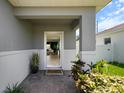 Welcoming front entryway featuring neutral colors, a decorative mat, and tiled floors at 14357 Hidden Ct, Clermont, FL 34711