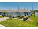 Attractive single-story house features a well-maintained lawn and two-car garage at 14357 Hidden Ct, Clermont, FL 34711