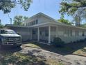 Inviting single-story home showcasing a covered front porch and well-manicured landscaping at 1526 Cordova Ave, Holly Hill, FL 32117