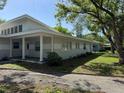 Charming single-story home with a covered front porch and mature trees at 1526 Cordova Ave, Holly Hill, FL 32117
