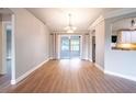 Dining area with wood floors and a view to the screened patio, perfect for entertaining at 1639 Yellow Brick Rd, Astor, FL 32102