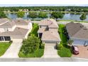 Aerial view of the home, showcasing its well-maintained lawn, and a tranquil lake at 1978 J Lawson Blvd, Orlando, FL 32824