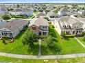 Aerial view of a home with a well-kept lawn in a neighborhood with manicured greenery at 1978 J Lawson Blvd, Orlando, FL 32824