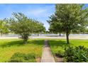 Landscaped front yard overlooking lake at 1978 J Lawson Blvd, Orlando, FL 32824