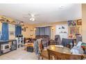 Inviting living room featuring tile floors, ceiling fan and multiple seating arrangements at 205 W Division St, Deland, FL 32720